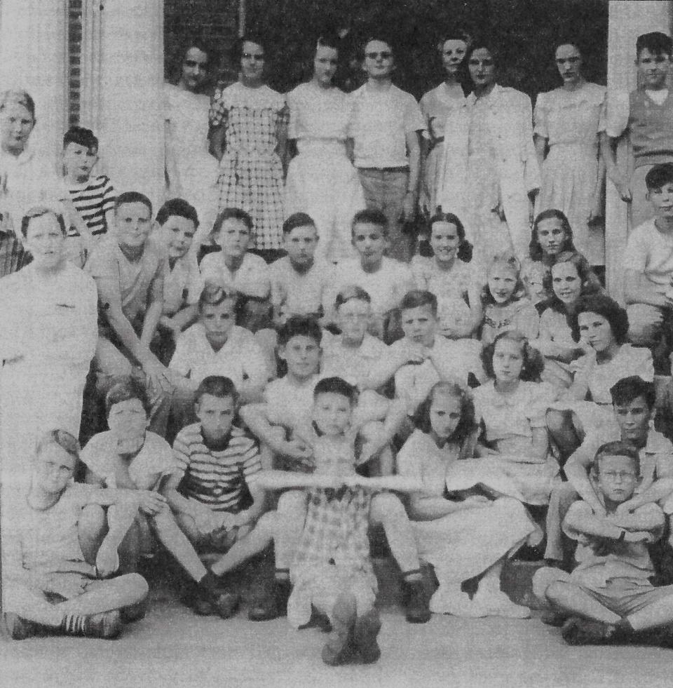 Forest Hills School class of 1947 shown in 1945 at the school entrance. Wilbur Jones is on middle row, left end, next to kid in sailor cap.