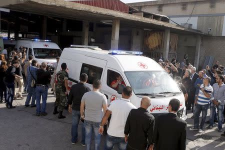 Ambulances carrying seven bodies of the Lebanese Safwan family drive past relatives and journalists at Beirut international airport, Lebanon October 21, 2015. REUTERS/Mohamed Azakir