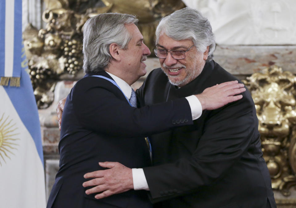 Argentina's President Alberto Fernandez, left, embraces Paraguay's former President Fernando Lugo, at the presidential palace in Buenos Aires, Argentina, Tuesday, Dec. 10, 2019. Fernandez became president of Argentina on Tuesday, returning the country's Peronist political movement to power amid an economic crisis and rising poverty. (AP Photo/Daniel Jayo)