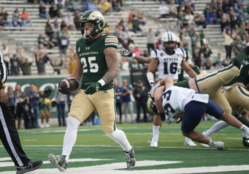 Colorado State running back Avery Morrow runs in for a touchdown in the first half of an NCAA college football game against Nevada on Saturday, Nov. 18, 2023, in Fort Collins, Colo. (AP Photo/David Zalubowski)