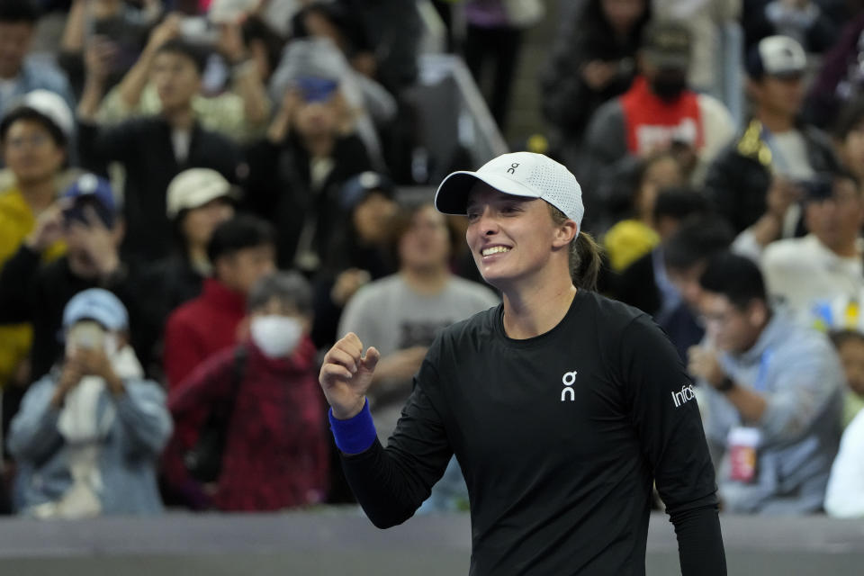 Iga Swiatek of Poland celebrates after defeating Liudmila Samsanova of Russia in the women's singles final match of the China Open tennis tournament at the Diamond Court in Beijing, Sunday, Oct. 8, 2023. (AP Photo/Andy Wong)