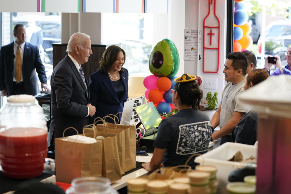 President Joe Biden and Vice President Kamala Harris talk with workers as they pick up food from Taqueria Habanero restaurant on Friday, May 5, 2023, in Washington. (AP Photo/Evan Vucci)