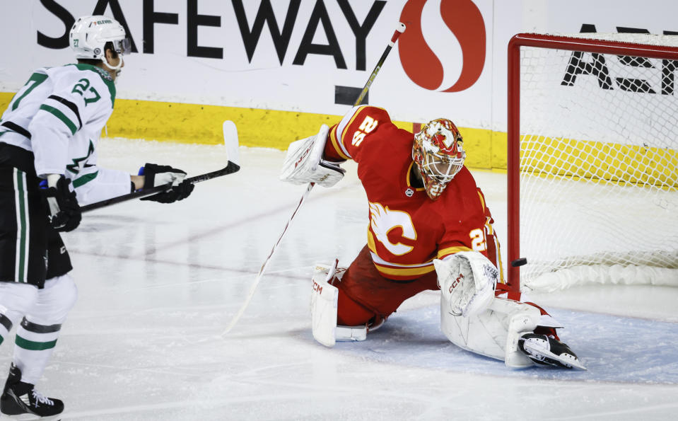 Dallas Stars forward Mason Marchment, left, scores on Calgary Flames goalie Jacob Markstrom during a penalty shot in the third period of an NHL hockey game in Calgary, Alberta, Thursday, Nov. 30, 2023. (Jeff McIntosh/The Canadian Press via AP)