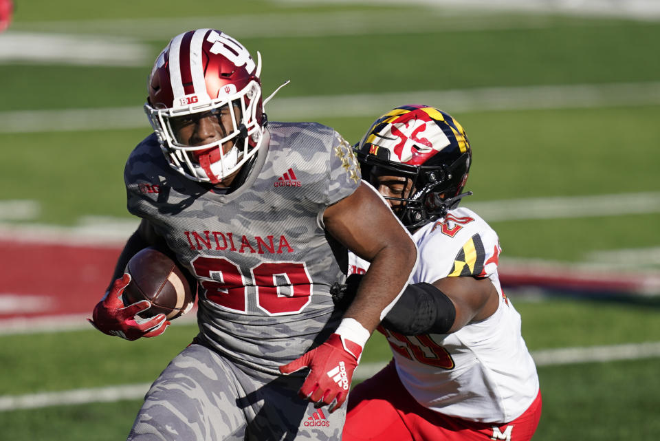 Indiana's Tim Baldwin Jr. (20) runs past Maryland's Antwaine Richardson (20) during the second half of an NCAA college football game, Saturday, Nov. 28, 2020, in Bloomington, Ind. Indiana won 27-11. (AP Photo/Darron Cummings)