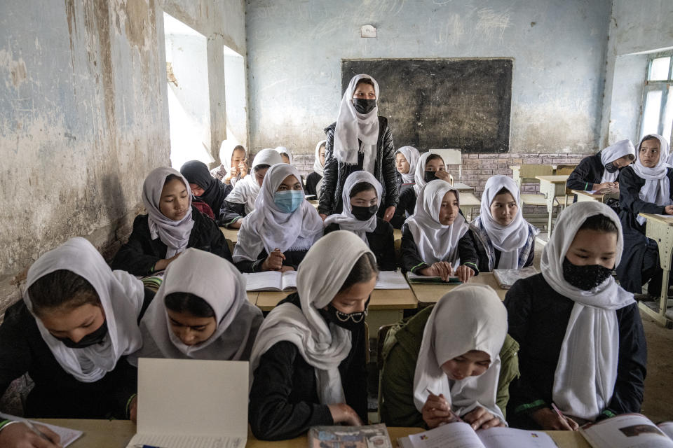 FILE - Afghan school girls attend their classroom on the first day of the new school year, in Kabul, Saturday, March 25, 2023. The Taliban's "abusive" educational policies are harming boys as well as girls in Afghanistan, according to a Human Rights Watch report published Wednesday. (AP Photo/Ebrahim Noroozi, File)