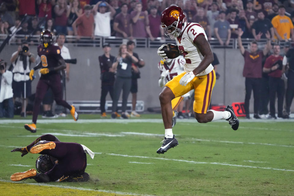 Southern California wide receiver Brenden Rice (2) scores a touchdown past Arizona State defensive back Demetries Ford during the first half of an NCAA college football game Saturday, Sept. 23, 2023, in Tempe, Ariz. (AP Photo/Rick Scuteri)