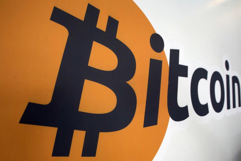 FILE PHOTO: A Bitcoin logo is displayed at the Bitcoin Center New York City in New York's financial district