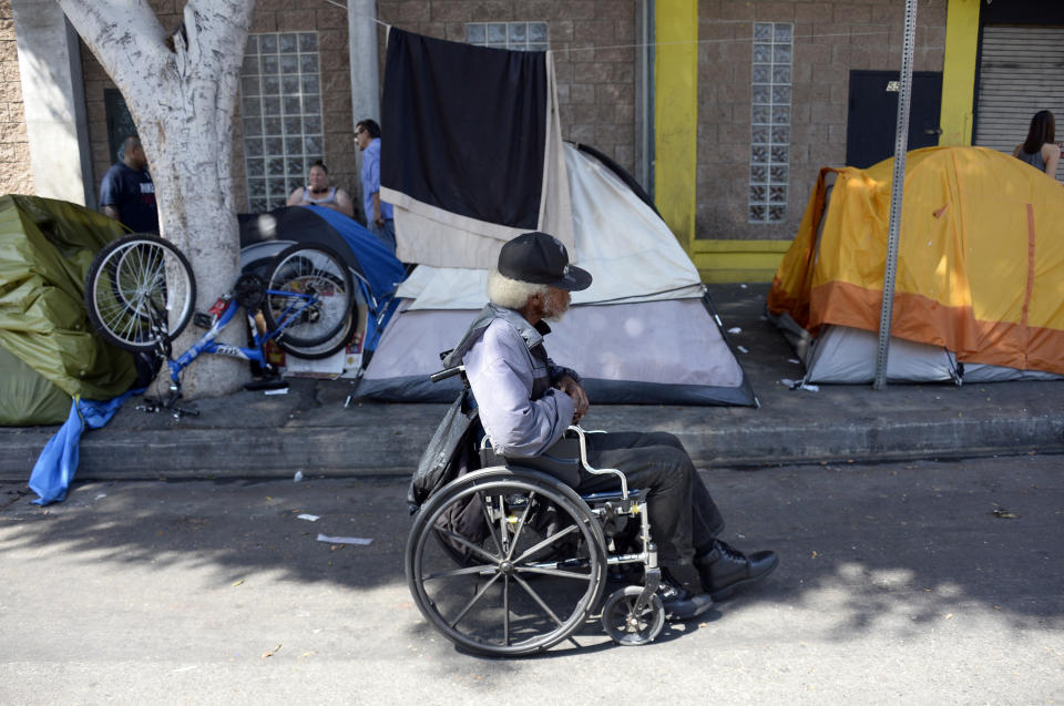 In Los Angeles' skid row area, a homeless man rolls down the street to a soup kitchen. (Photo: Kevork Djansezian via Getty Images)