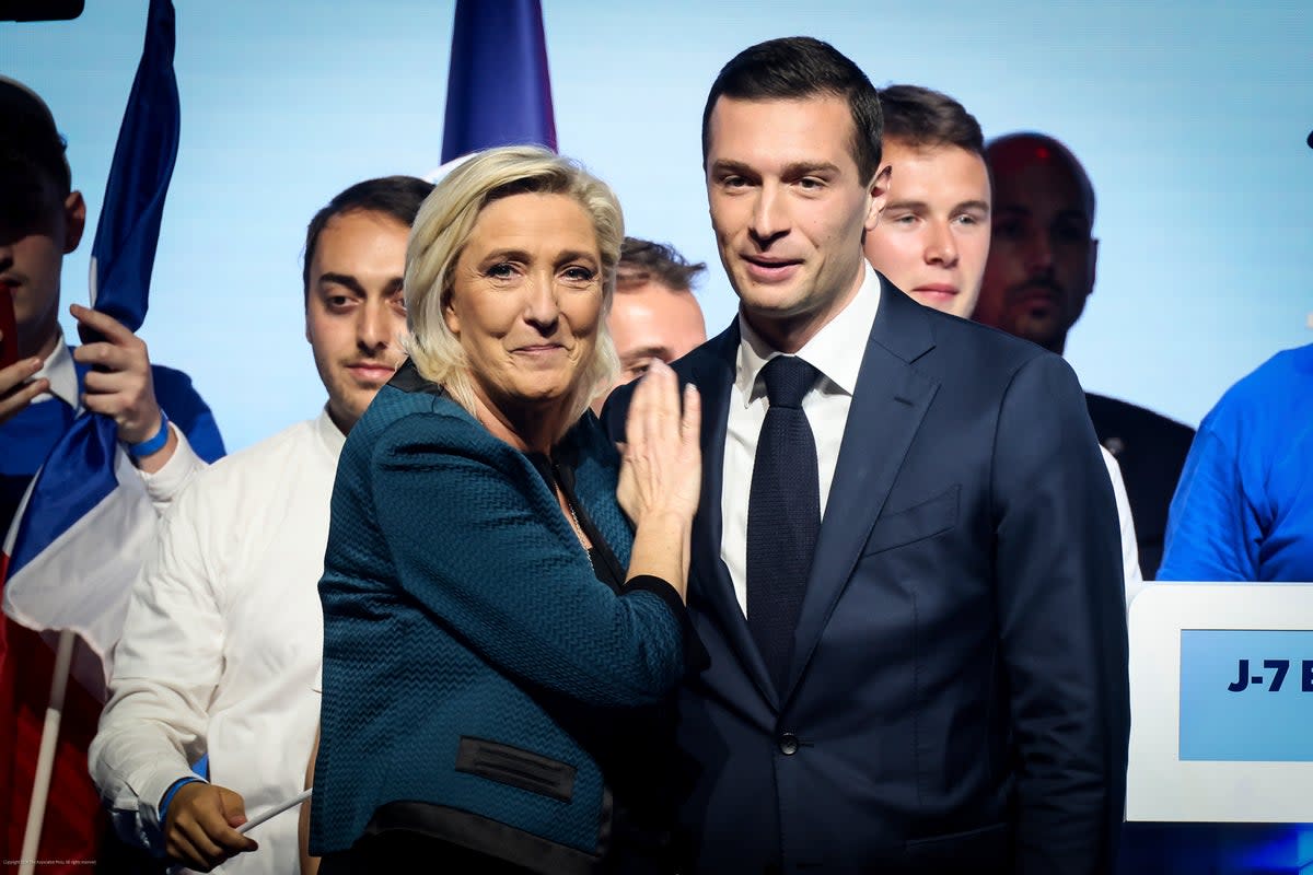 Marine Le Pen and Jordan Bardella of the French far-right National Rally during a political meeting in Paris (AP)