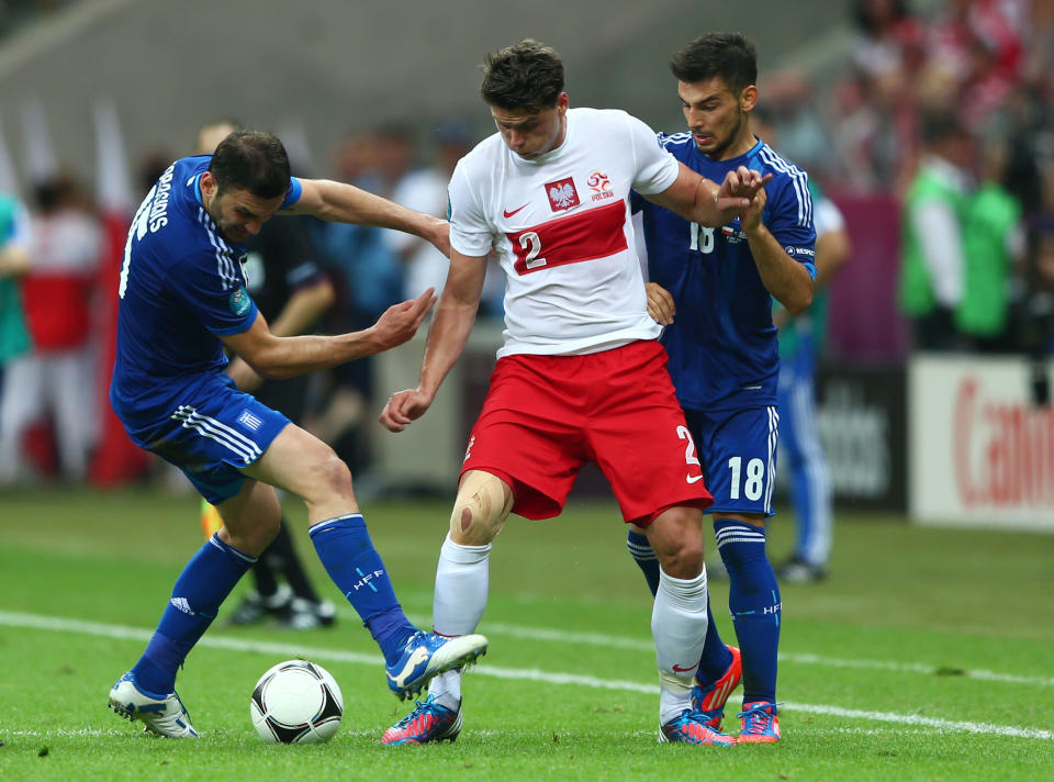 WARSAW, POLAND - JUNE 08: Sotiris Ninis and Vasilis Torosidis of Greece close down Sebastian Boenisch of Poland during the UEFA EURO 2012 group A match between Poland and Greece at The National Stadium on June 8, 2012 in Warsaw, Poland. (Photo by Michael Steele/Getty Images)