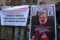 Muslim devotees shout anti Indian slogans and hold placards outside Jamia Masjid after Friday prayers conducted for the first time since August 5 at the main mosque of Jamia Masjid in Srinagar on December 20, 2019, after Indian authorities had closed the mosque as part of a security lockdown. - On August 5, authorities in Indian-administered Kashmir locked the Jamia Masjid in the main city of the disputed region, barring all prayers there as part of a series of unprecedented restrictions imposed before New Delhi unilaterally stripped the territory of its semi-autonomous status. (Photo by Tauseef MUSTAFA / AFP) (Photo by TAUSEEF MUSTAFA/AFP via Getty Images)