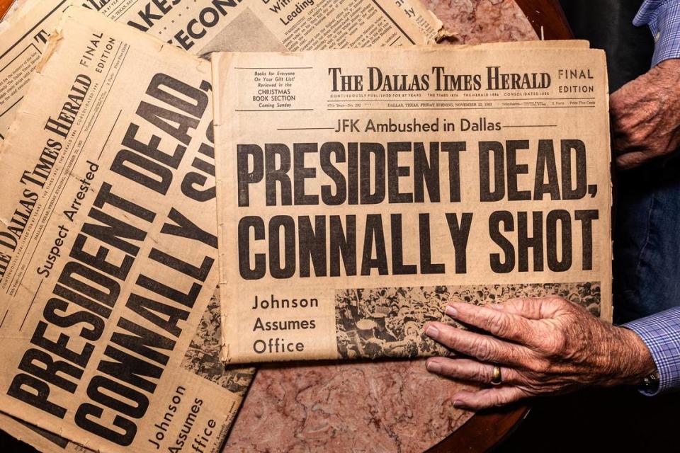 Darwin Payne, a former Dallas Times Herald reporter who covered the assassination of President John F. Kennedy, shows the original Dallas Times Herald newspapers distributed following Kennedy’s assassination on Nov. 23, 1963.