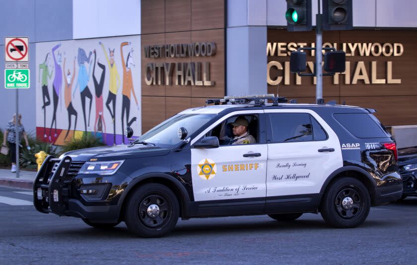 West Hollywood, CA - October 28: A Los Angeles Sheriff Deputy patrols past the West Hollywood City Hall along Santa Monica Blvd. in West Hollywood at sunset Thursday, Oct. 28, 2021. (Allen J. Schaben / Los Angeles Times)d