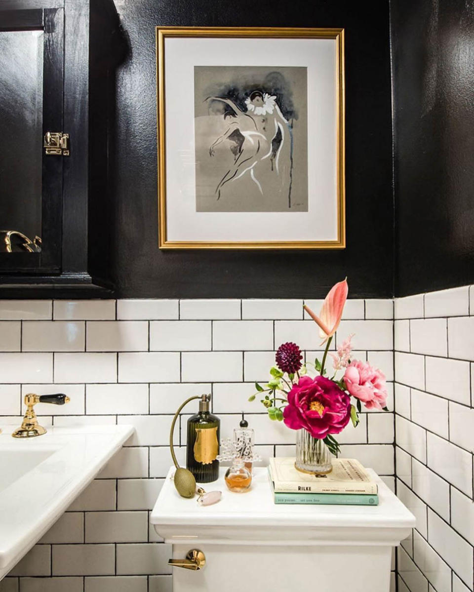 In the bathroom, Natasha went with herringbone floor tiles from Nero Marquina and an enamel-and-brass faucet from Rohl.