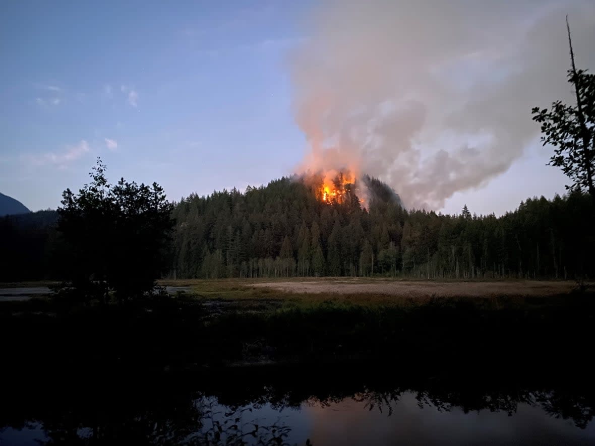 A fire sparked in Minnekhada Regional Park near Coquitlam, B.C. on Saturday, Oct. 1 is burning on steep, rocky terrain, making it difficult for crews to get to. (Metro Vancouver/Twitter - image credit)