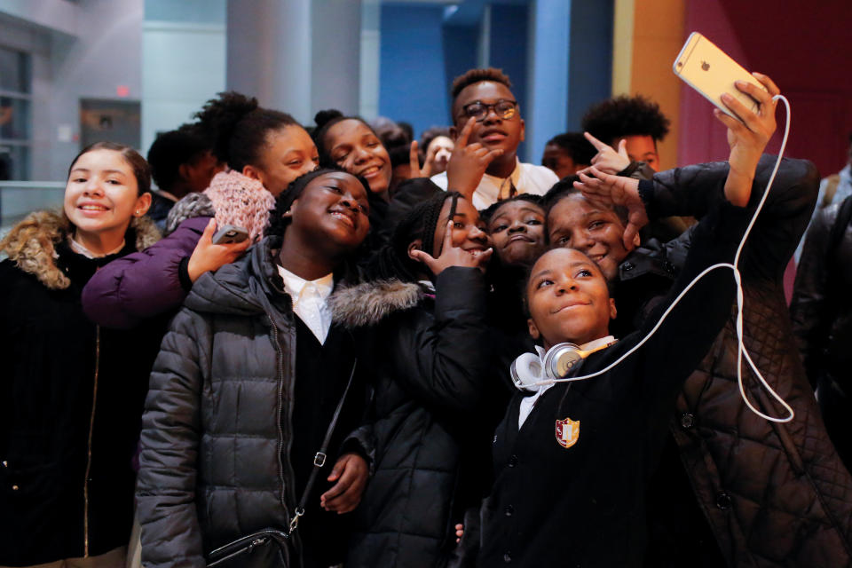 A group of children takes a selfie as they arrive on the opening night of the film "Black Panther" at the AMC Magic Johnson Harlem 9 cinemas in Manhattan, New York, on Feb. 15, 2018.