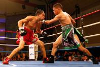 KISSIMMEE, FL - OCTOBER 19: Boxer Orlando Cruz (R) trades punches with boxer Jorge Pazos at Kissimmee Civic Center on October 19, 2012 in Kissimmee, Florida. (Photo by J. Meric/Getty Images)