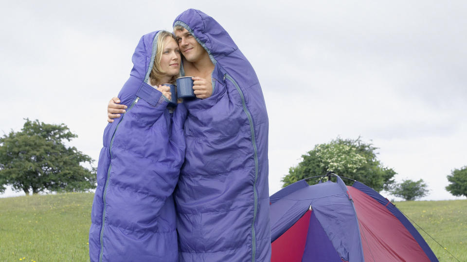 Couple in Sleeping Bags Hug