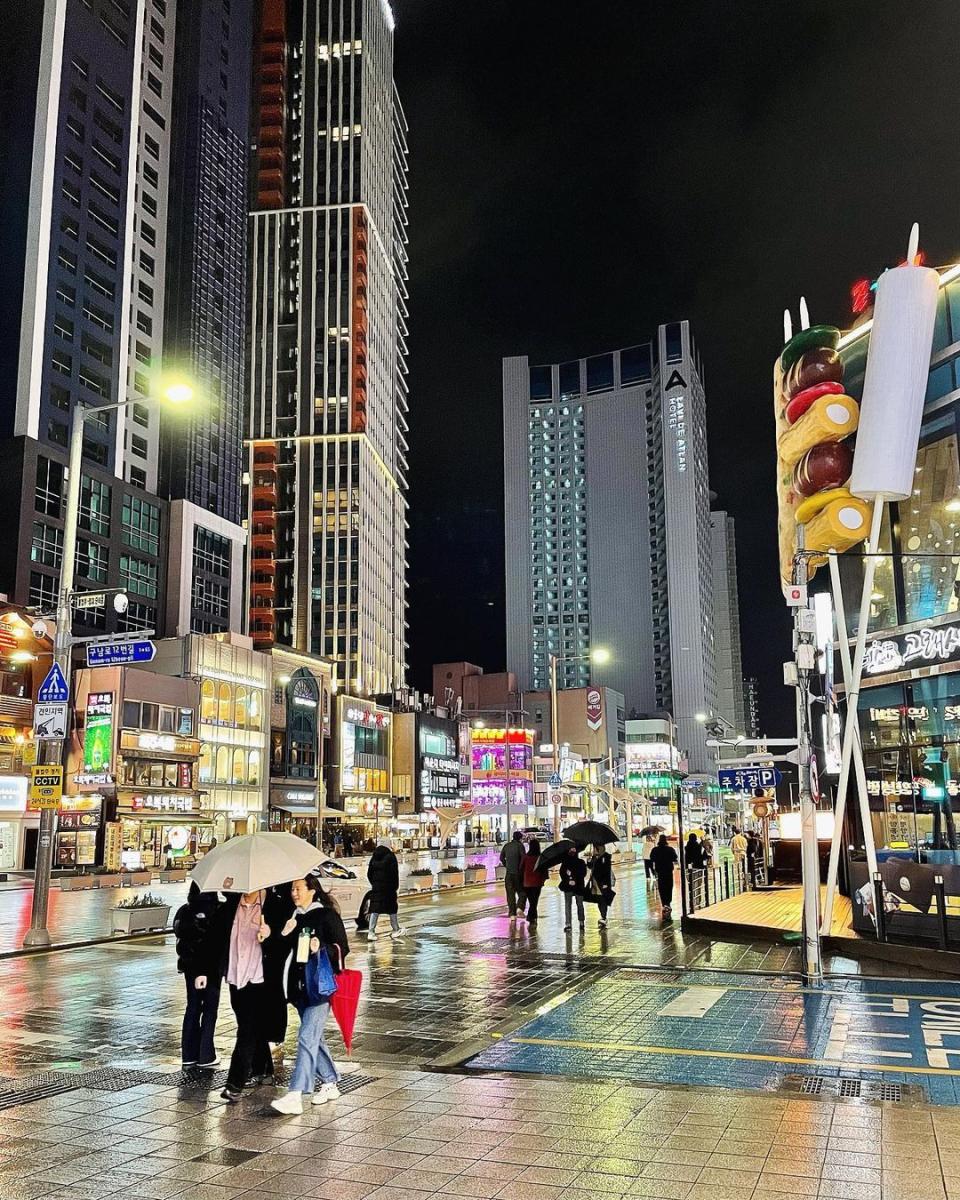 people walking in busan at night