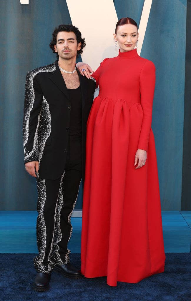 Joe and Sophie on the red carpet, with her hand resting on his shoulder