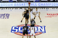 Mercer forward James Glisson III (23) and UNC-Greensboro forward Mohammed Abdulsalam (4) tip off for the start of an NCAA men's college basketball championship game for the Southern Conference tournament, Monday, March 8, 2021, in Asheville, N.C. (AP Photo/Kathy Kmonicek)