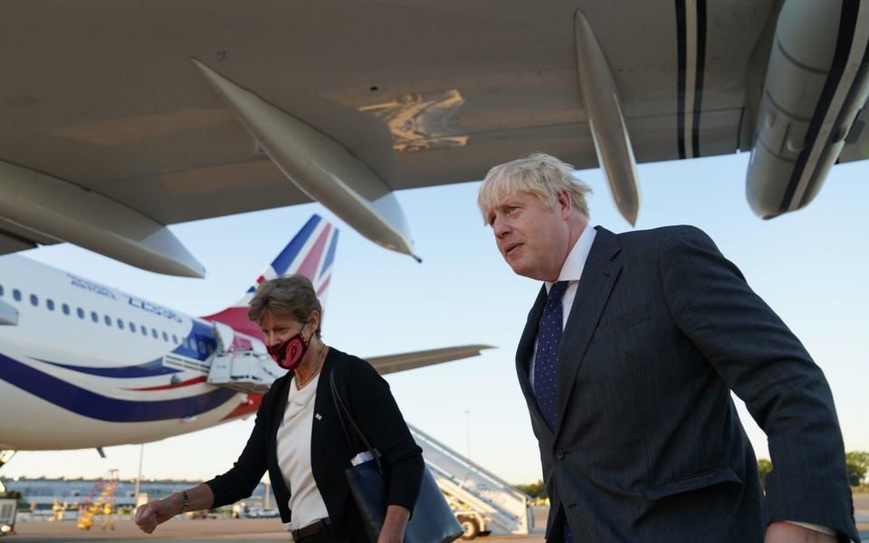 Prime Minister Boris Johnson with Dame Barbara Janet Woodward, the UK's Permanent Representative to the United Nations, as he lands in New York's JFK airport - PA