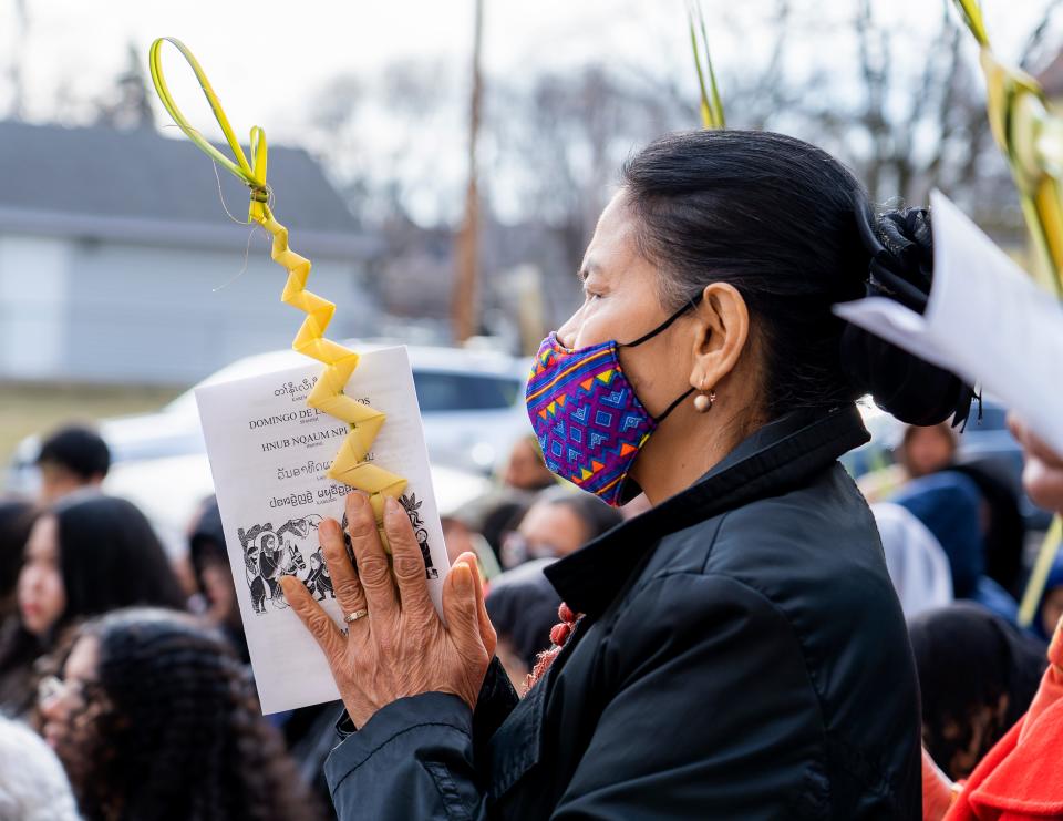 Melissa Msouthle of Milwaukee prays as the Rev. Rafael Rodriguez offers a blessing at Palm Sunday Mass at St Michael's Catholic Church in Milwaukee.