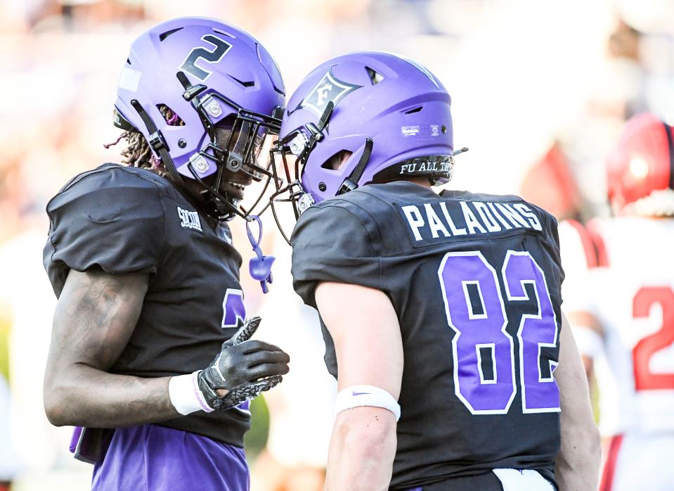 Furman Paladins wide receiver Joshua Harris (2) and Furman Paladins tight end Ryan Miller (82) celebrate after scoring against North Greenville Crusaders at Paladin Stadium in Greenville, Thursday, September 1, 2022.