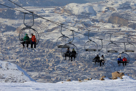 FILE PHOTO: People ride a ski lift at the Mzaar Kfardebian Ski Resort on Mount Lebanon January 12, 2017.REUTERS/Jamal Saidi/File Photo