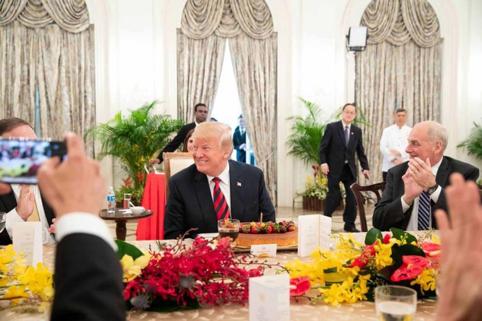 Prime Minister Lee Hsien Loong of Singapore surprises Donald Trump with a birthday cake in 2018.