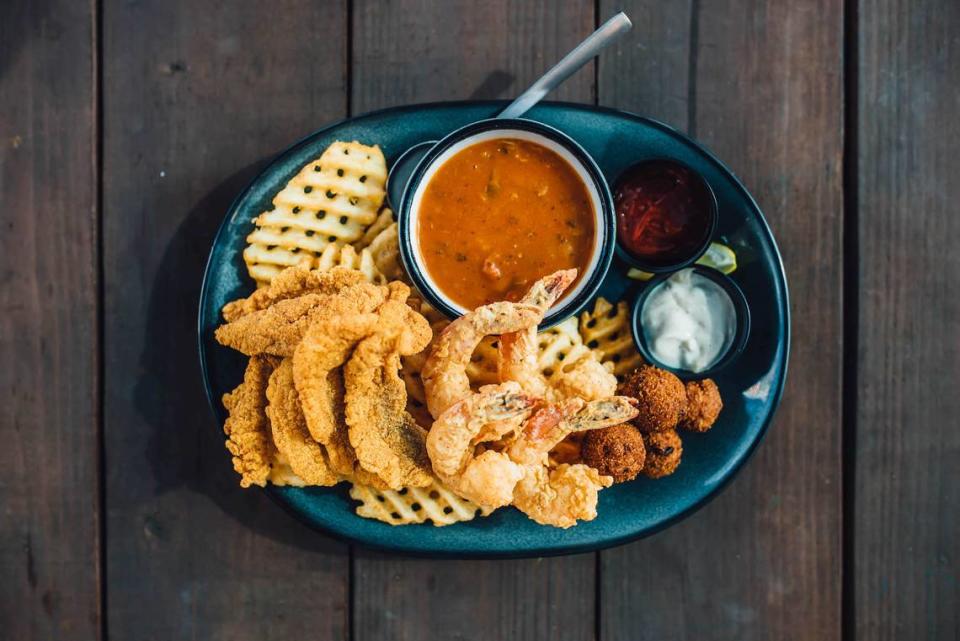 The Louisiana Combo includes fried shrimp, fried catfish, hush puppies, crawfish étouffée and a side of fries.