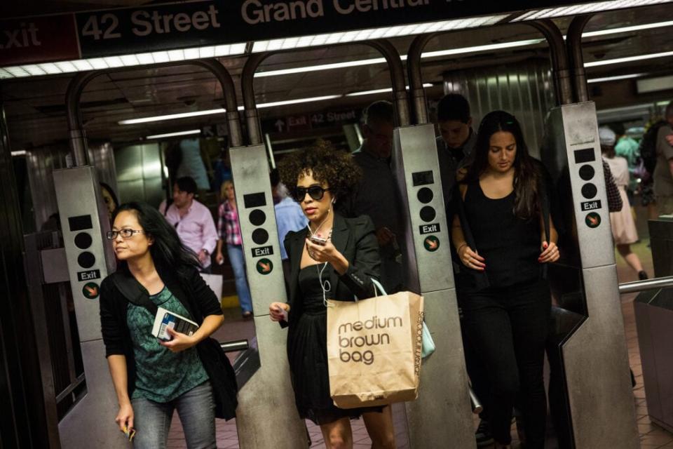 People rush through the New York City subway system at rush hour on August 14, 2013 in New York City. (Photo by Andrew Burton/Getty Images)