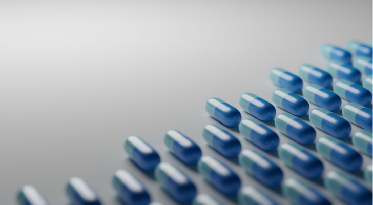 Light blue pills on white background. Pharmaceutical industry, medical treatment, presciption drugs concept. Digital 3D render., biotech stocks, big pharma. REVB stock