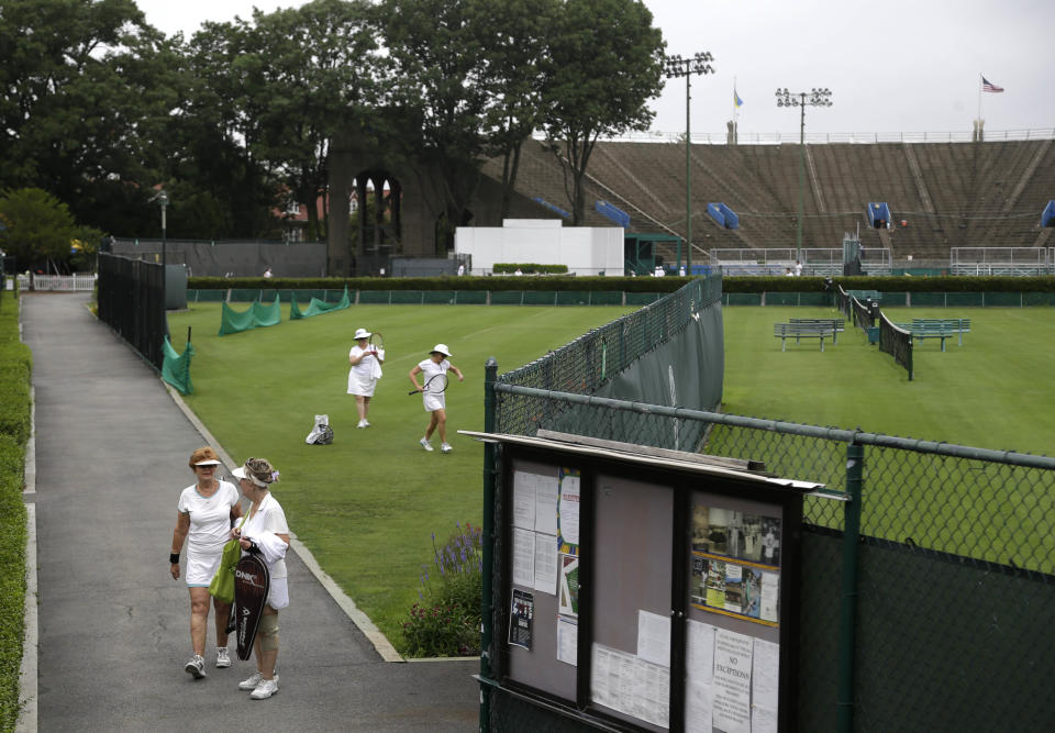 In this Tuesday, July 2, 2013 photo, the stadium at the West Side Tennis Club is seen behind the grass courts in the Queens section of New York. The Beatles. The Rolling Stones. Frank Sinatra. Jimi Hendrix. Bob Dylan. They’ve all held court at the more than century-old West Side Tennis Club in Queens’ Forest Hills neighborhood - for six decades the site of the U.S. Open Tennis Championships. Plans are now in the works for the grassy lawn to come alive again with the sound of music, starting with a concert featuring the British band Mumford & Sons, to be followed by a lineup of world-class musicians. (AP Photo/Seth Wenig)