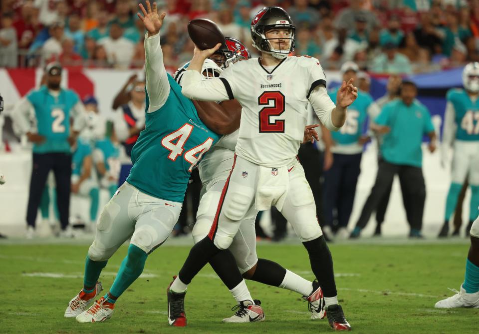 Dolphins rookie edge rusher Chop Robinson (44) tries to reach Bucs quarterback Kyle Trask during Friday night's preseason finale in Tampa.