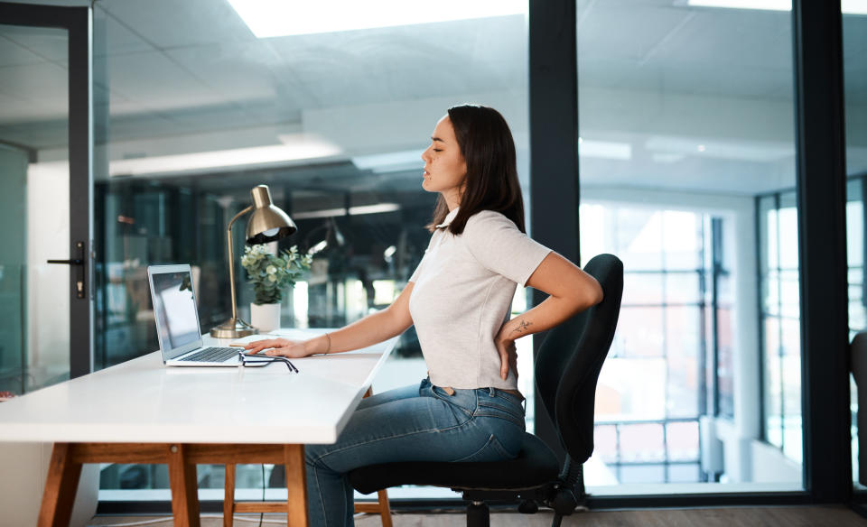 A footrest can help alleviate back pain and improve posture while you sit (Image via Getty Images)