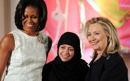 Former US First Lady Michelle Obama and former Secretary of State Hillary Clinton pose with Samar Badawi of Saudi Arabia as she receives the 2012 International Women of Courage Award in 2012.  - Getty