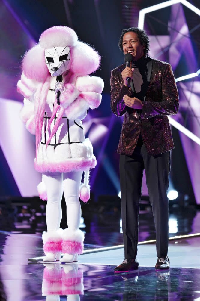 Cannon, with a contestant dressed as a poodle, hosting Fox's <em>The Masked Singer</em>.