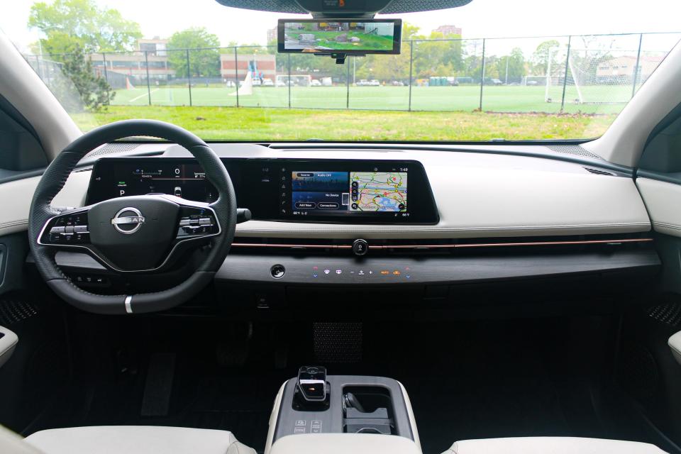 The interior of the 2023 Nissan Ariya Empower+ electric SUV, as seen from the back seat looking toward the windshield.