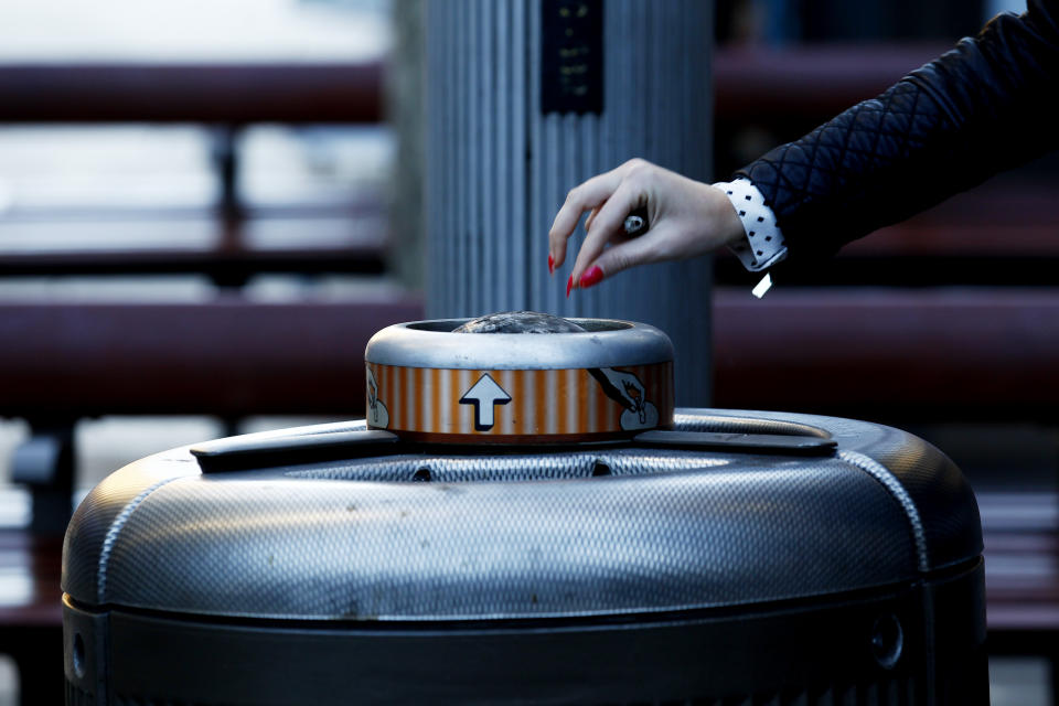 A worker puts out a cigarette in the Sydney major CBD. 