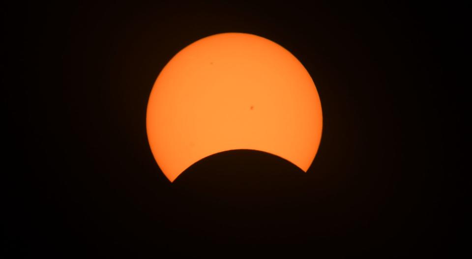 The start of the total solar eclipse, as viewed from the north patio of the Bayfront Convention Center in Erie on Monday.