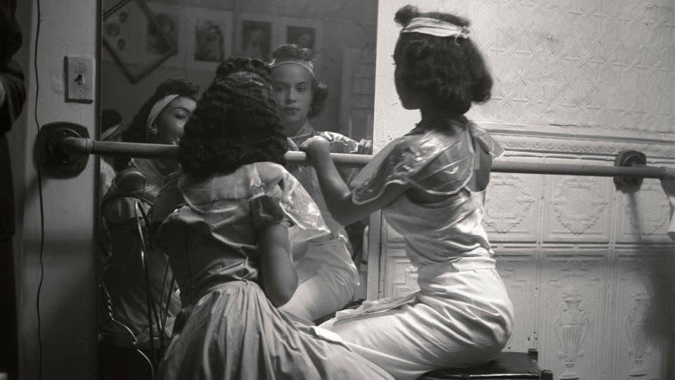 Two young Black models check their makeup backstage, shot by Arnold, in Harlem, 1950. - Eve Arnold/Courtesy Newlands House Gallery