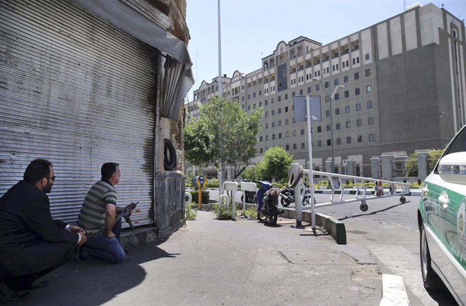 FILE - Security personnel take position in front of Iran's parliament building after an assault of several attackers, in Tehran, Iran on June 7, 2017. An Iranian court issued a $312.9 million judgement against the United States over a 2017 Islamic State-claimed attack on Tehran, authorities said Wednesday, April 26, 2023, the latest judicial action between the nations amid their decadeslong enmity. (Omid Vahabzadeh/Fars News Agency via AP, File)