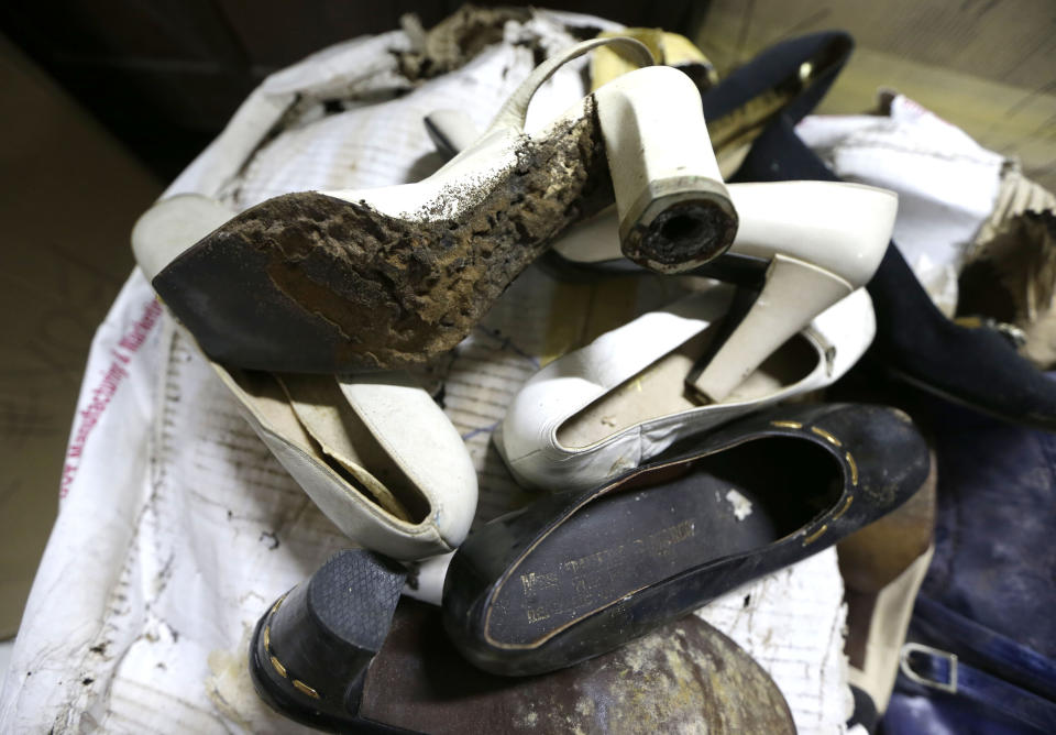 In this photo taken Sept. 19, 2012, a branded high heel shoe, once worn by flamboyant former Philippine first lady Imelda Marcos, sits among equally-damaged shoes in a section of the National Museum in Manila, Philippine. Termites, storms and government neglect have damaged some of Imelda Marcos's legendary stash of shoes, expensive gowns and other vanity possessions, which were left to oblivion after she and her dictator husband were driven to U.S. exile by a 1986 popular revolt. (AP Photo/Bullit Marquez)