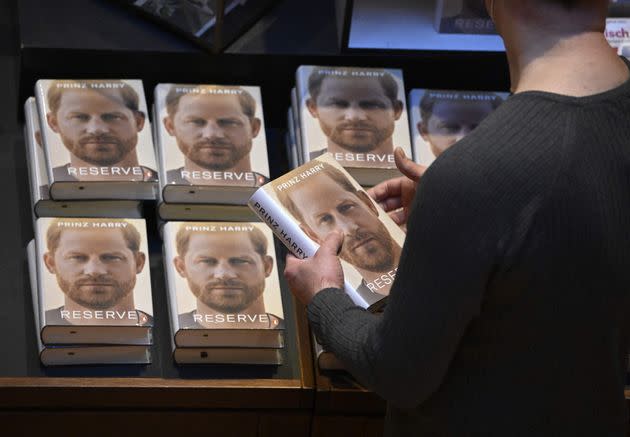 A bookseller prepares a display for the German translation of 