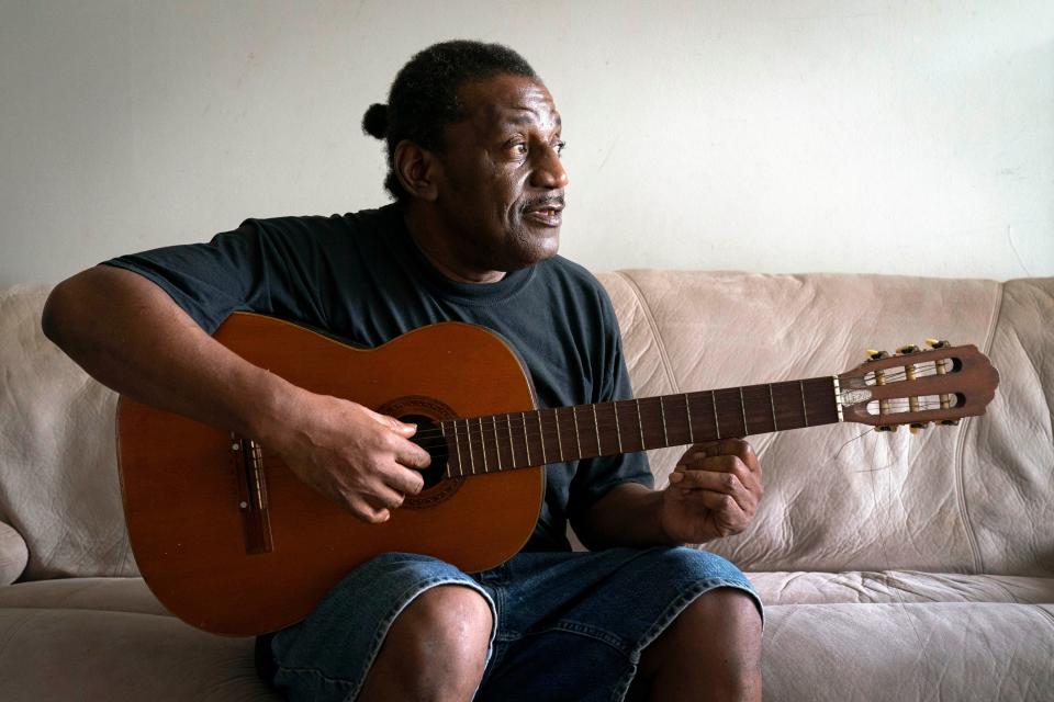 Army veteran Reginald Ware holds his guitar in his apartment in West Palm Beach, Florida on November 4, 2021.
