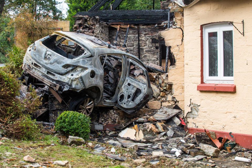 A driver has been arrested after car crashed into a house on the A38 in Cornwall. 19th October 2020  See SWNS story SWPLcrash. This dramatic picture shows the damage caused after a car crashed into a house before bursting into flames. The motorist ploughed into the home on the A38 causing both the property and car to catch fire. The roof was burned away, leaving charred beams and smoke damaged walls. The trapped driver was taken to Derriford Hospital in Plymouth, Devon, following the crash in Bodmin, Cornwall on Sunday at around 7.30pm.See SWNS story SWPLcrash. This dramatic picture shows the damage caused after a car crashed into a house before bursting into flames. The motorist ploughed into the home on the A38 causing both the property and car to catch fire. The roof was burned away, leaving charred beams and smoke damaged walls. The trapped driver was taken to Derriford Hospital in Plymouth, Devon, following the crash in Bodmin, Cornwall on Sunday at around 7.30pm.