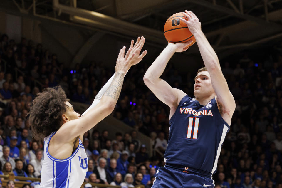 Virginia's Isaac McKneely (11) attempts a shot over Duke's Tyrese Proctor, left, during the first half of an NCAA college basketball game in Durham, N.C., Saturday, Mar. 2, 2024. (AP Photo/Ben McKeown)