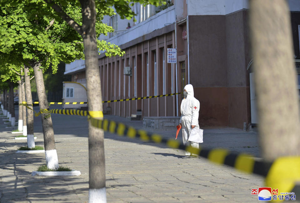 In this photo provided by the North Korean government, a worker in protective gear stands on an empty sidewalk in Pyongyang, North Korea Tuesday, May 17, 2022. Independent journalists were not given access to cover the event depicted in this image distributed by the North Korean government. The content of this image is as provided and cannot be independently verified. Korean language watermark on image as provided by source reads: "KCNA" which is the abbreviation for Korean Central News Agency. (Korean Central News Agency/Korea News Service via AP)