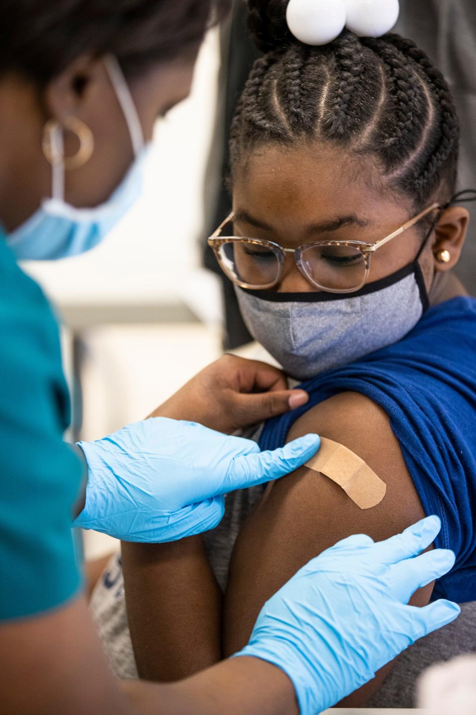 Laryah Wakefield, 10, looks on as she receives a COVID-19 vaccine at Carter Traditional Elementary School in Louisville, Kentucky, during a vaccine drive Saturday morning, Nov. 13, 2021.